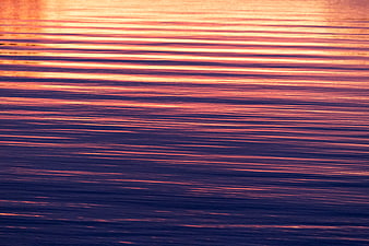 Abstract Sunset Reflections on Rippled Water Surface