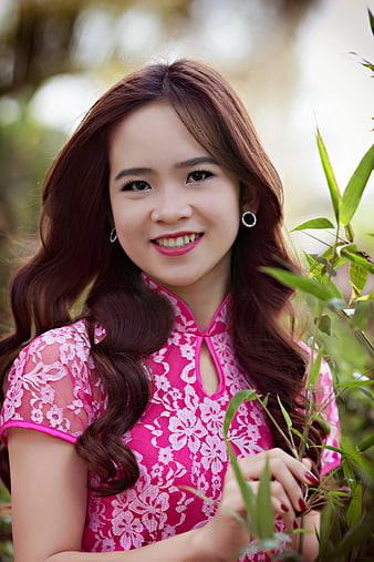 Smiling Asian Woman in Pink Lace Ao Dai