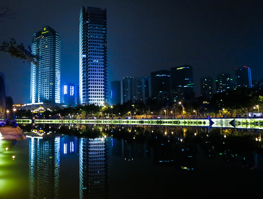 Night cityscape with skyscrapers reflected in water