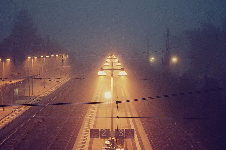 Foggy Train Station Platform at Night with Streetlights