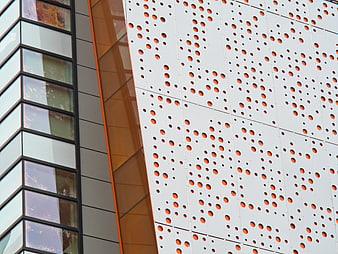 Modern Perforated Metal Facade with Orange Accents