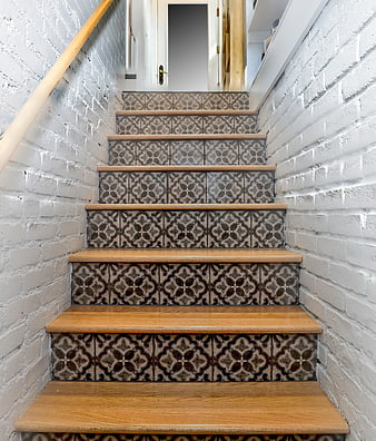 Modern Staircase with Patterned Tiles and White Brick Walls