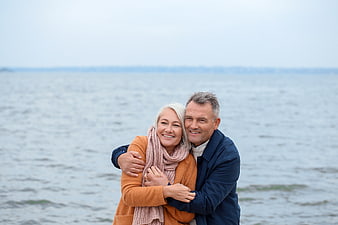 Happy Senior Couple Hugging by the Sea