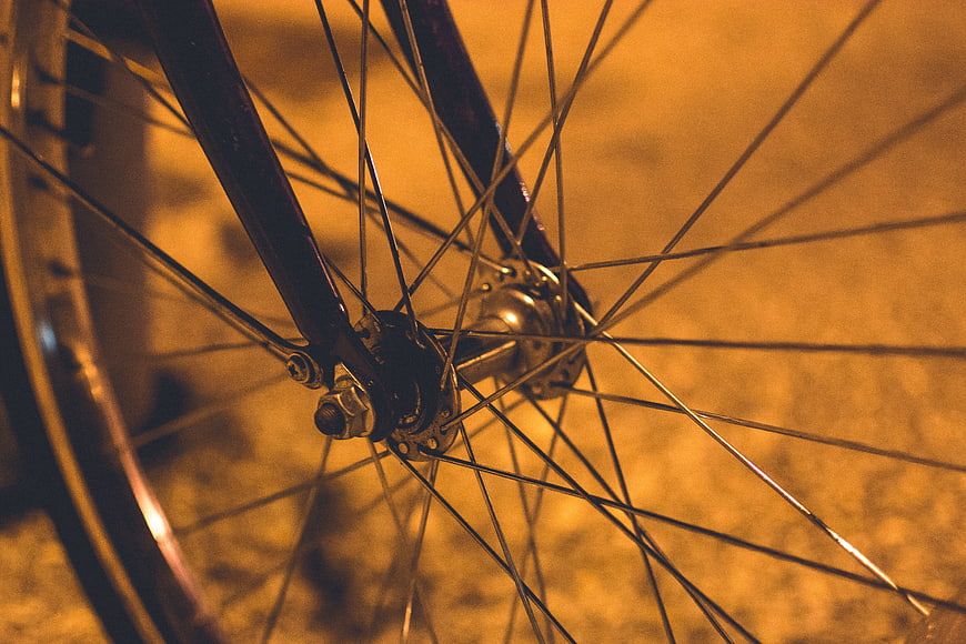 Close-up of bicycle wheel spokes and hub at night