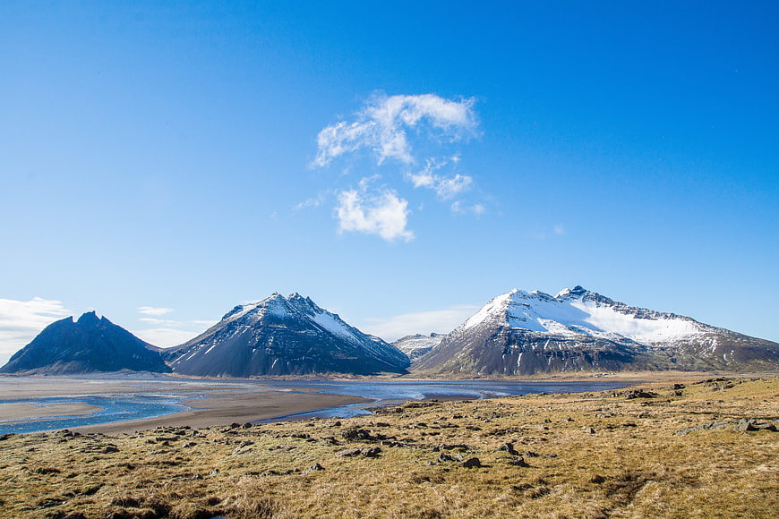 Snow-capped mountains and river in Icelandic landscape