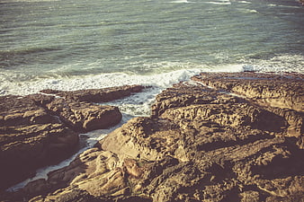 Rugged coastal rocks with crashing ocean waves