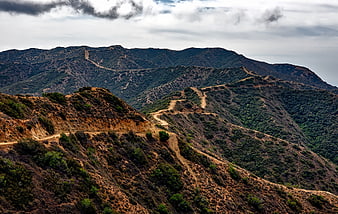 Winding dirt road through rugged mountain landscape