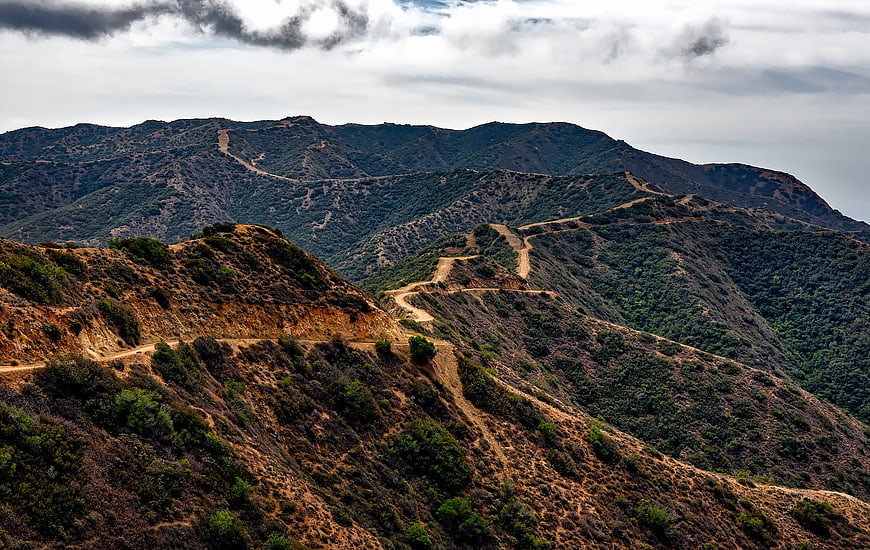 Winding dirt road through rugged mountain landscape