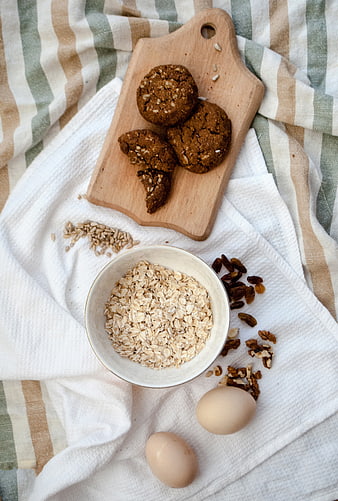 Healthy oatmeal cookies with ingredients on wooden board and linen cloth