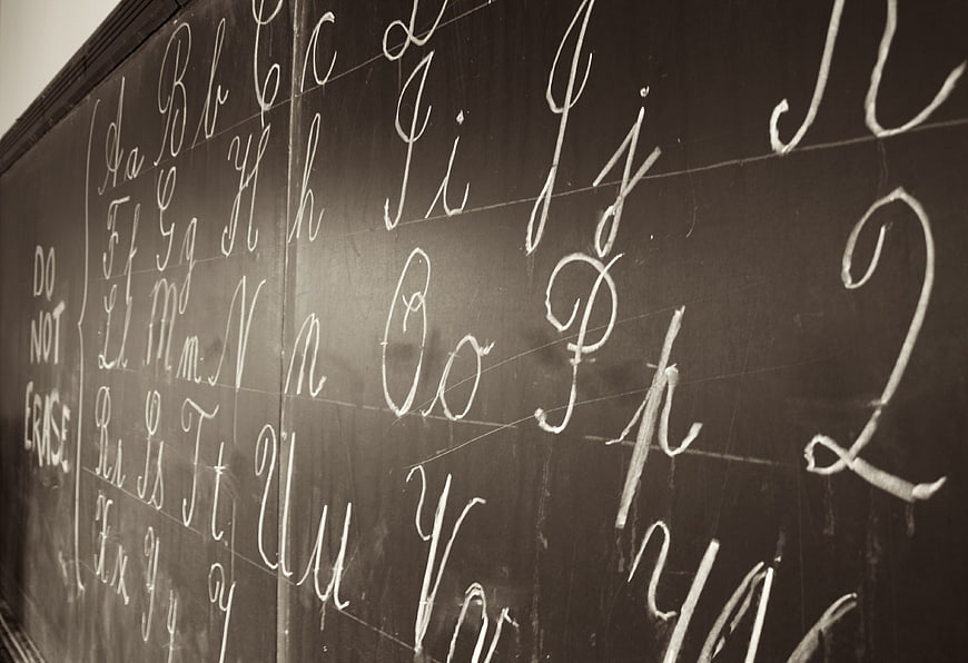Cursive Alphabet Letters Written in Chalk on Blackboard