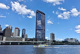 Sydney skyline with tall skyscraper and ferry on water