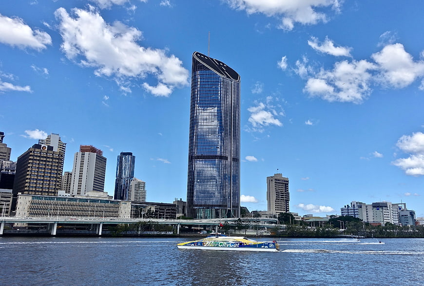 Sydney skyline with tall skyscraper and ferry on water