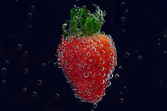 Fresh Strawberry Submerged in Sparkling Water with Bubbles