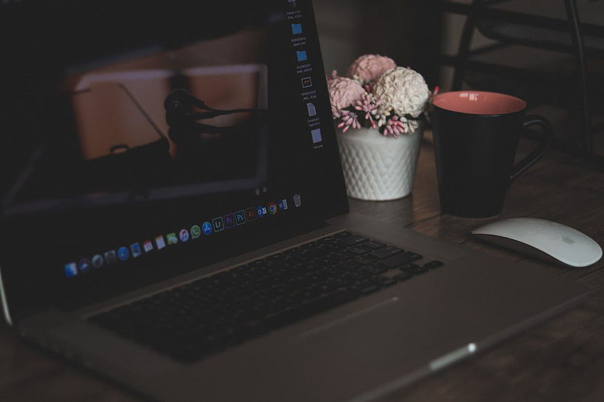 Dark Moody Workspace with Laptop, Coffee, and Flowers