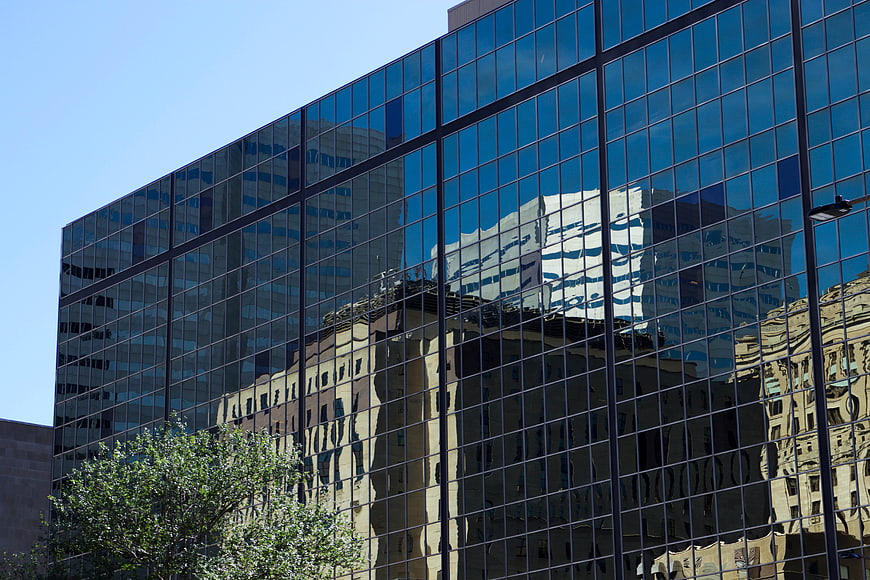Modern Glass Office Building with City Reflections
