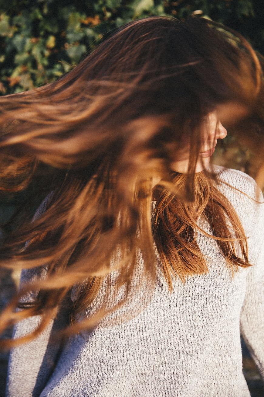 Woman with flowing hair in sunlight