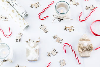 Christmas Flat Lay with Wooden Reindeer, Candy Canes, and Wrapping Paper