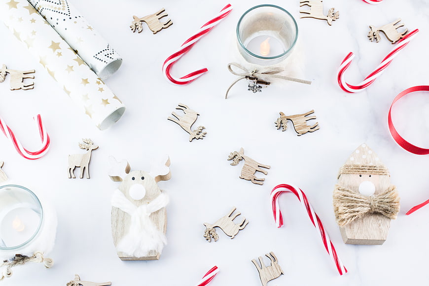 Christmas Flat Lay with Wooden Reindeer, Candy Canes, and Wrapping Paper