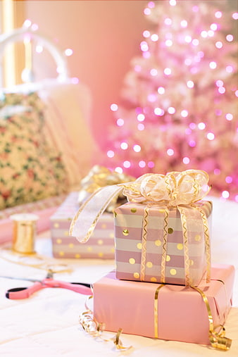 Pink Christmas Gift Wrapping Scene With Festive Tree Background