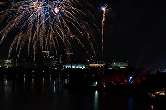 Fireworks exploding over city skyline at night