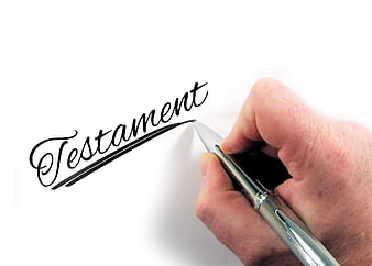 Hand writing Testament with pen on white paper