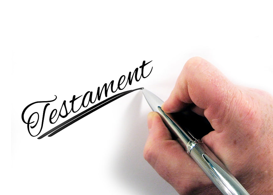 Hand writing Testament with pen on white paper