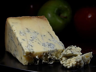 Stilton Blue Cheese Wedge With Apples On Dark Background
