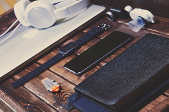 Flat lay of tech gadgets on rustic wooden desk