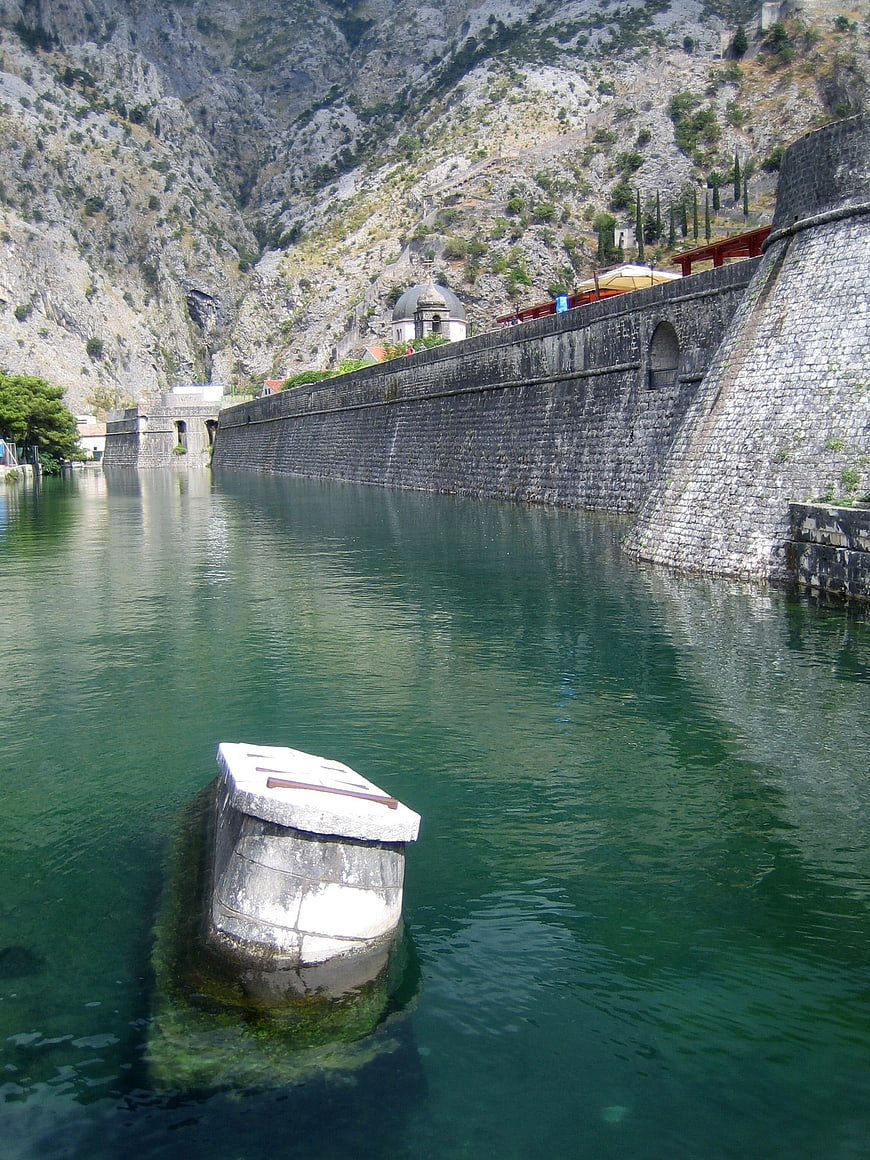 Stone fortress wall along river in Kotor Bay, Montenegro