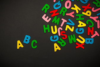 Colorful Wooden Alphabet Letters Scattered On Black Background