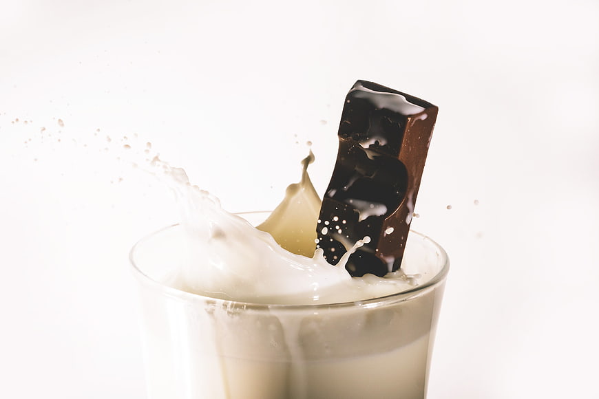 Chocolate Bar Dropped into Glass of Milk Splash