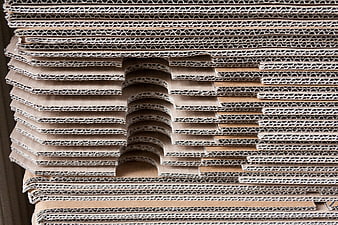 Stack of corrugated cardboard sheets with cutouts