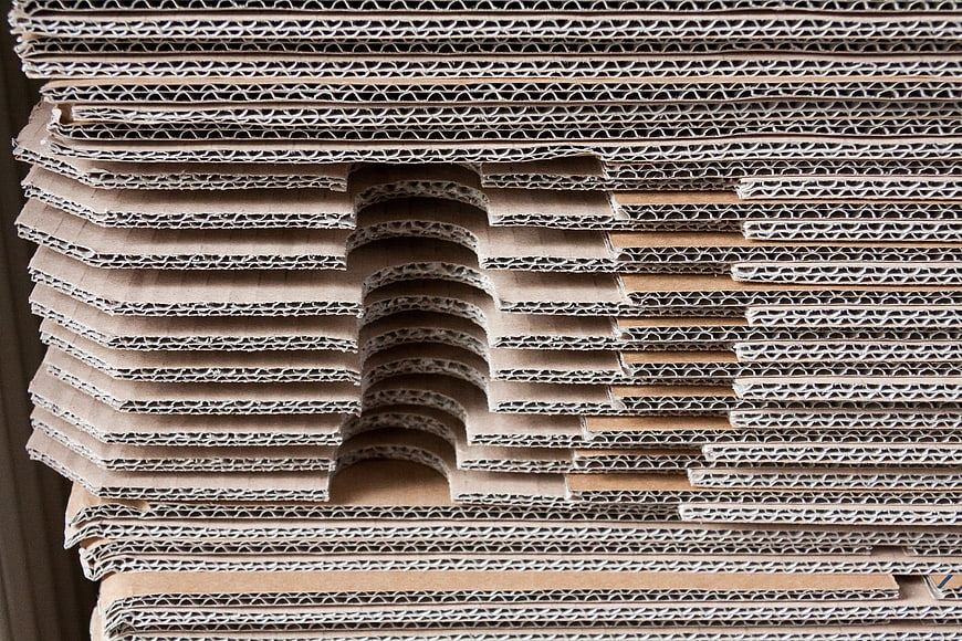 Stack of corrugated cardboard sheets with cutouts