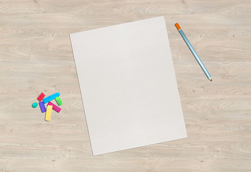 Blank Paper with Crayons and Pencil on Wooden Table