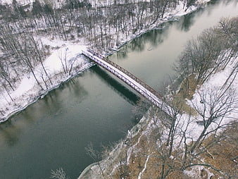 Aerial View of Snow-Covered Bridge Over Winter River