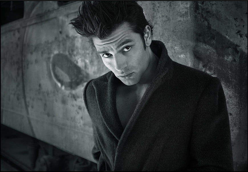 Intense black and white portrait of a man in a coat
