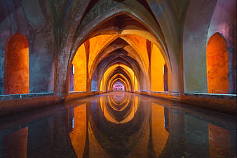 Reflective Gothic Arches in Flooded Historic Hallway