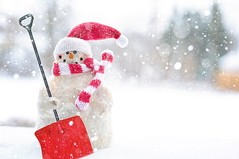 Snowman with Santa Hat and Red Shovel in Snowy Winter Landscape