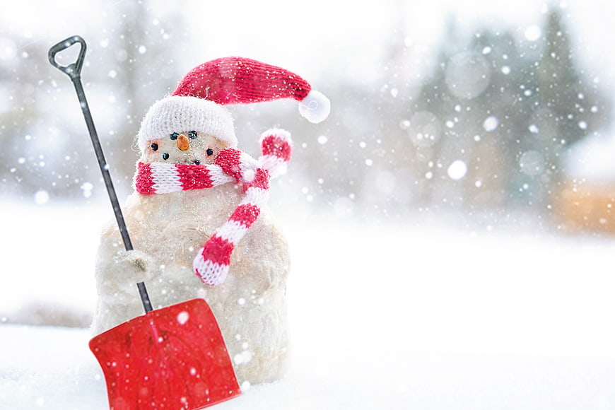Snowman with Santa Hat and Red Shovel in Snowy Winter Landscape