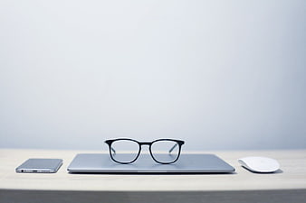 Minimalist Workspace with Laptop, Glasses, and Smartphone