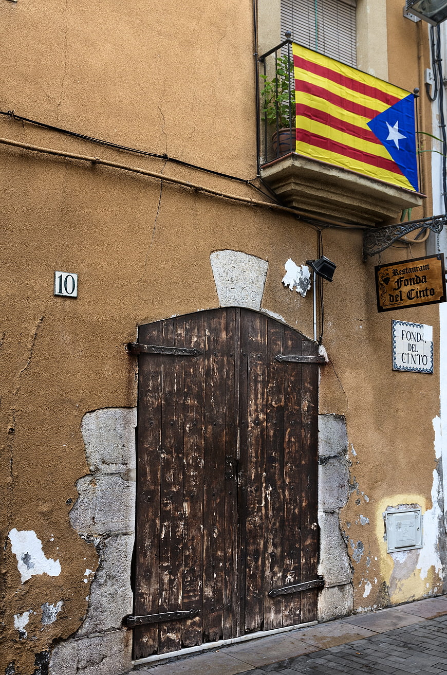 Old wooden door with Catalan independence flag on balcony