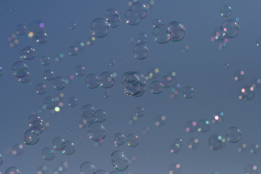 Abstract Soap Bubbles Floating Against Blue Background