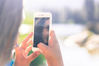 Woman Taking Photo of Lake with Smartphone