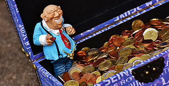 Money shark figurine in treasure chest full of coins