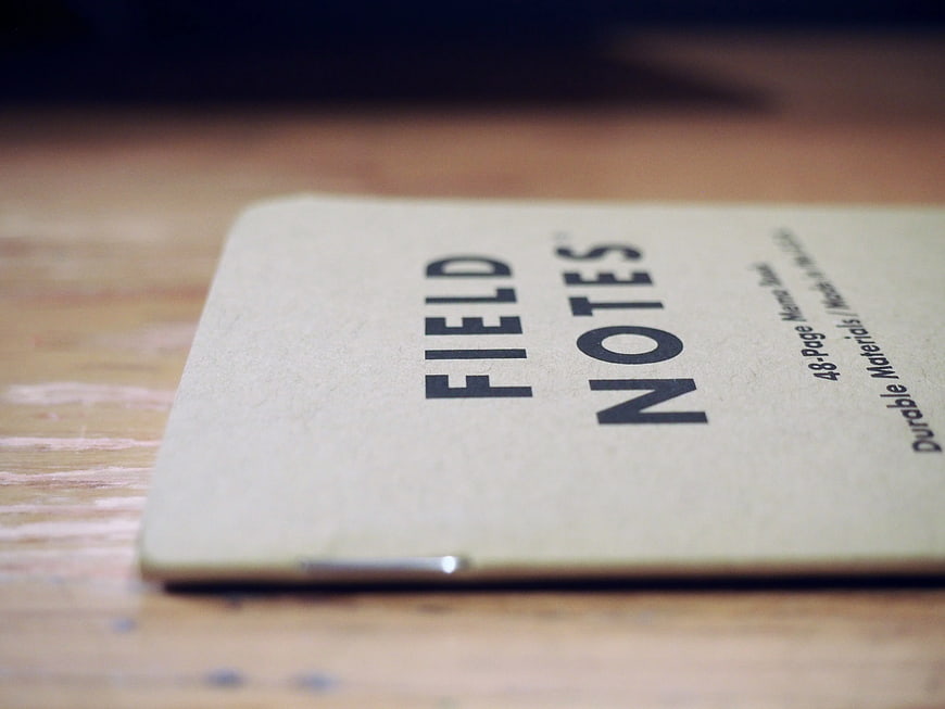 Close-up of Field Notes Notebook on Wooden Desk