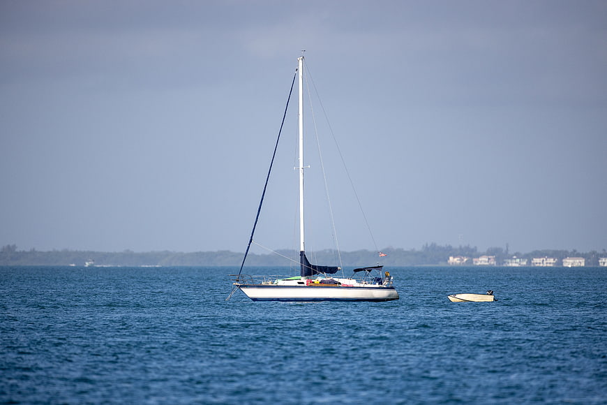 White Sailboat Anchored in Blue Ocean Water