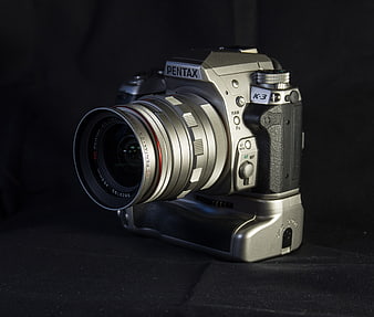 Silver Pentax K-3 Camera with Lens on Black Background