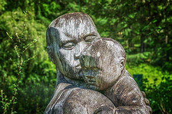 Wooden Sculpture of Mother and Child Embracing in Nature