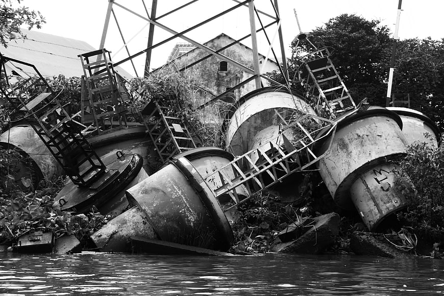 Abandoned industrial metal structures and scrap waste in black and white