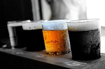 Flight of craft beers on a wooden tasting paddle